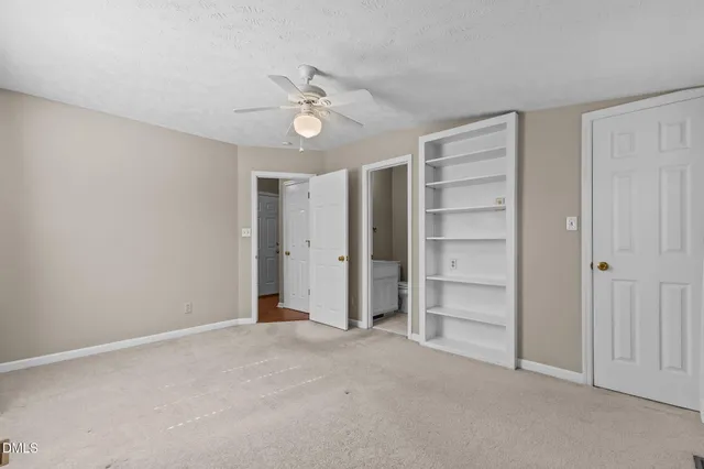 an empty room with an empty space and a ceiling fan