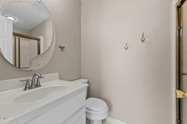 a living room with a fireplace and potted plants