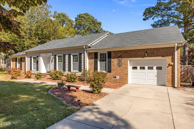 a front view of house with yard outdoor seating and green space
