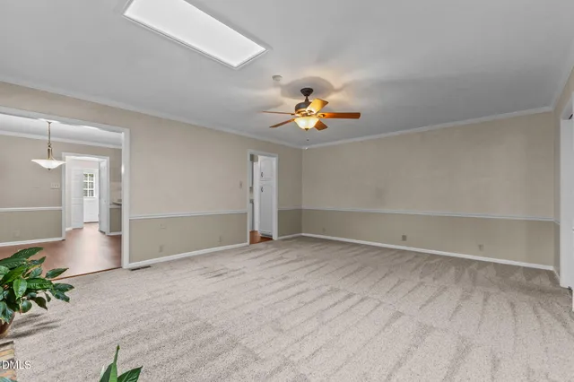 a view of an empty room with a fireplace and a window