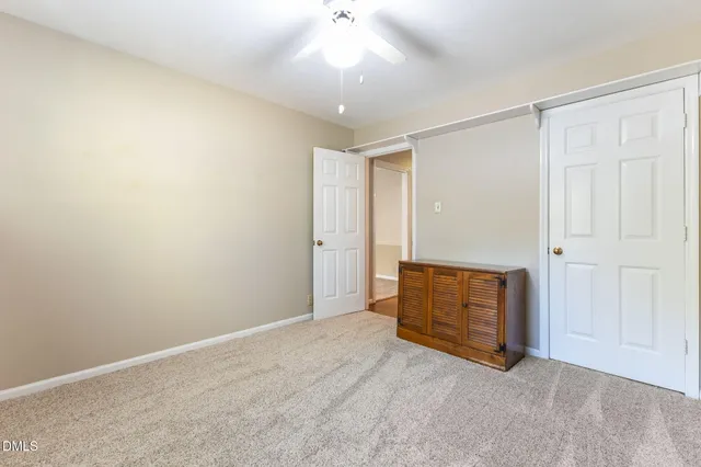 a view of a livingroom with a ceiling fan and window