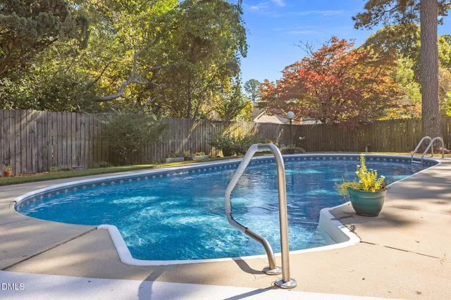 a view of a house with swimming pool and sitting area