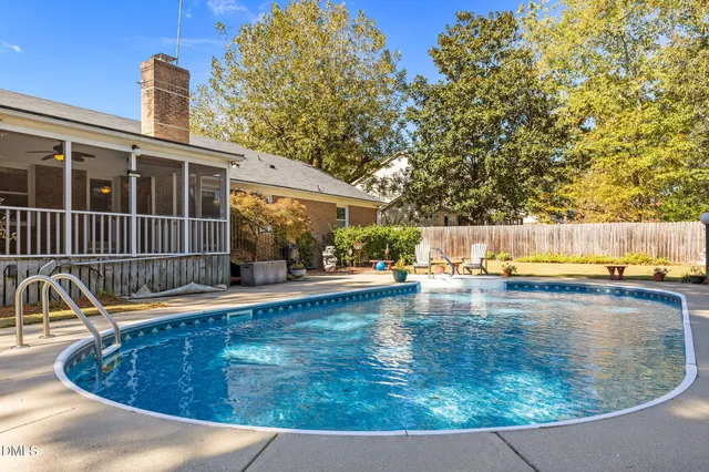 a front view of house with yard and swimming pool