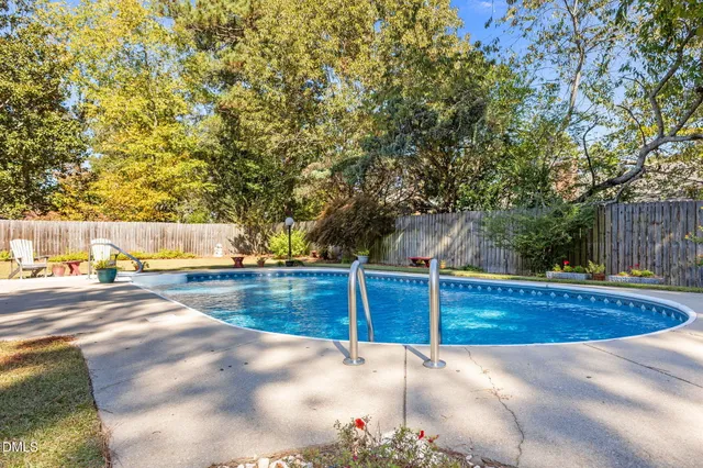a view of a house with swimming pool and sitting area