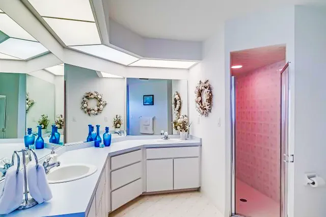 a bathroom with a double vanity sink mirror and double