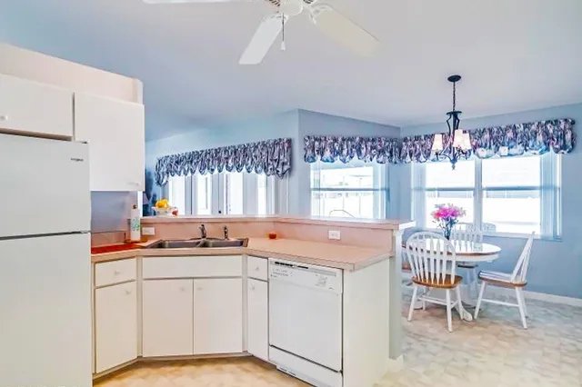 a kitchen that has a lot of counter space and a dining table