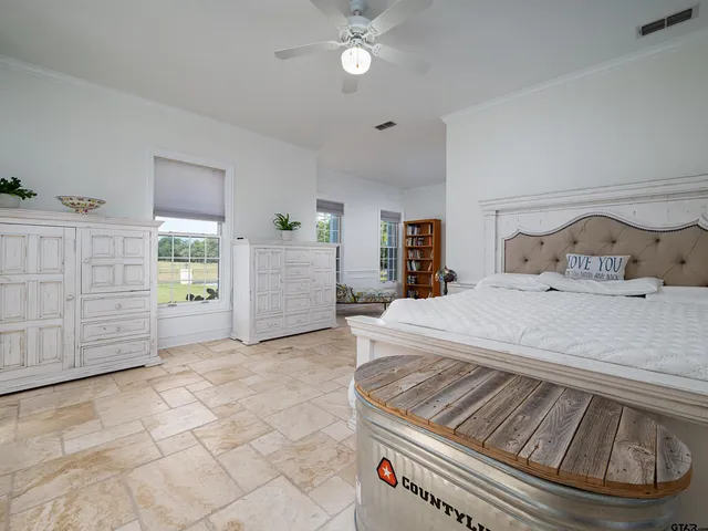 a spacious bedroom with a bed and a cabinets