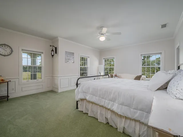 a bedroom with a bed wooden floor and window