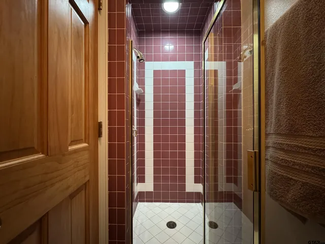 a bathroom with a shower and a sink