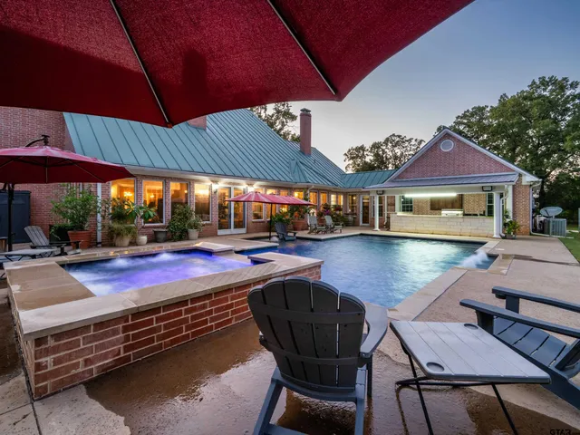 a view of a swimming pool with outdoor seating space