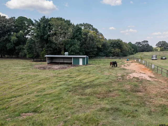 a view of a lake with a yard and trees