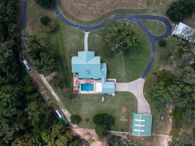 an aerial view of a house with outdoor space