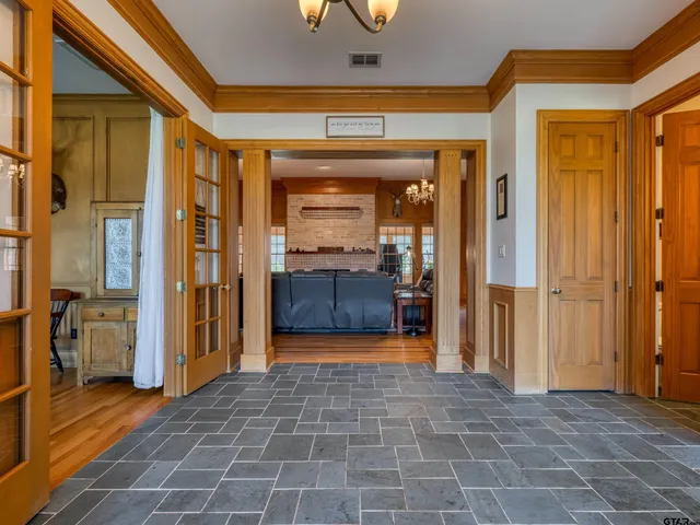 a view of a hallway with wooden shelves