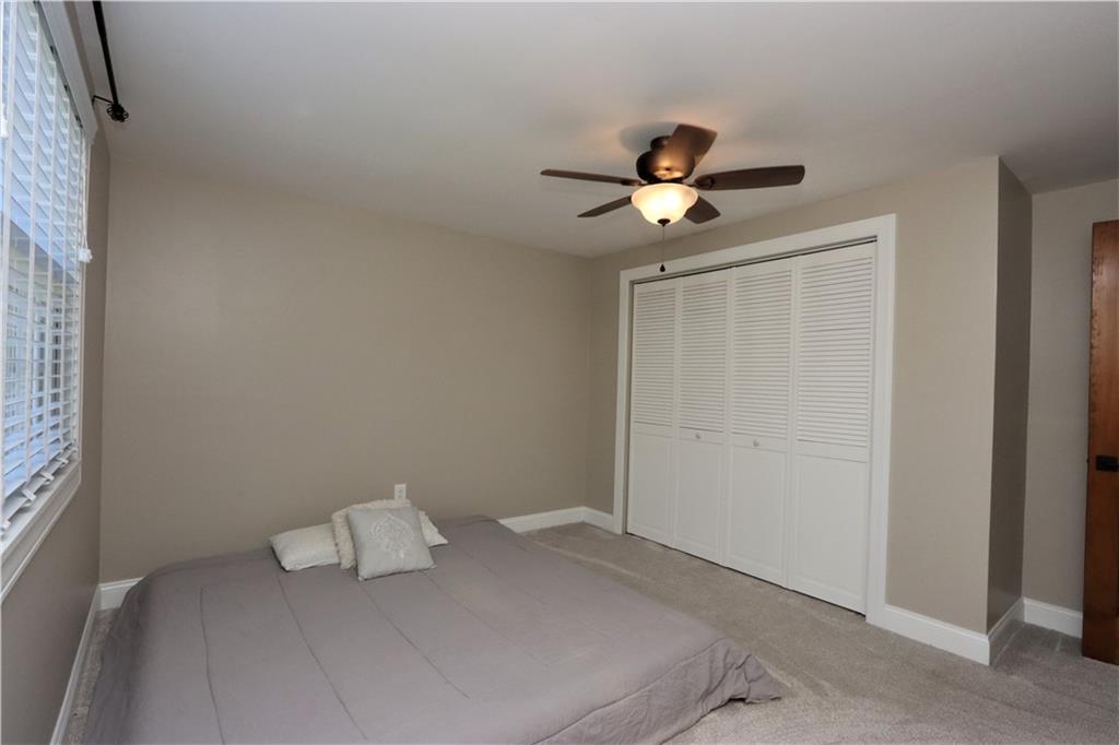 169 Mary Reed Road Baden, PA 15005 - Photo 14 of 24 a bedroom with a bed and a ceiling fan