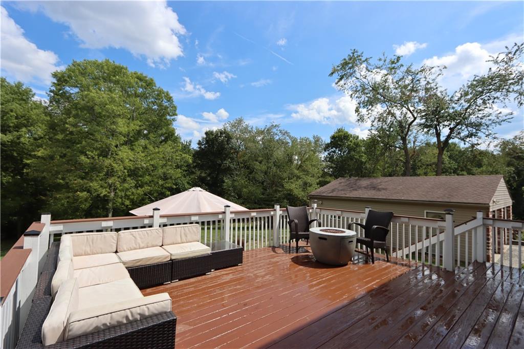169 Mary Reed Road Baden, PA 15005 - Photo 17 of 24 a view of a roof deck with table and chairs under an umbrella with wooden floor