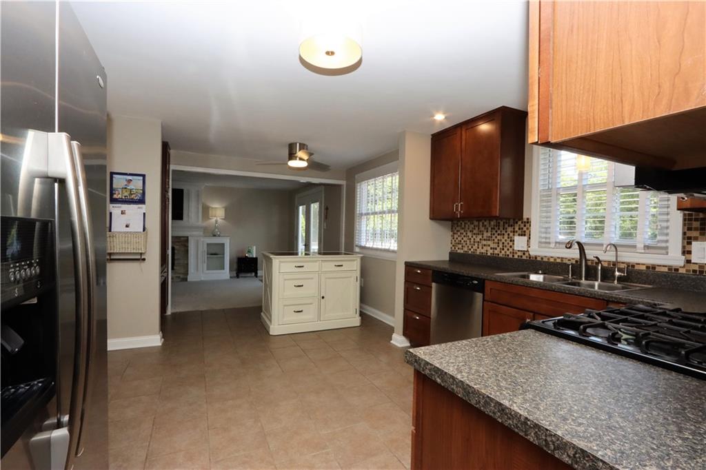 169 Mary Reed Road Baden, PA 15005 - Photo 8 of 24 a kitchen with stainless steel appliances granite countertop a sink stove and refrigerator
