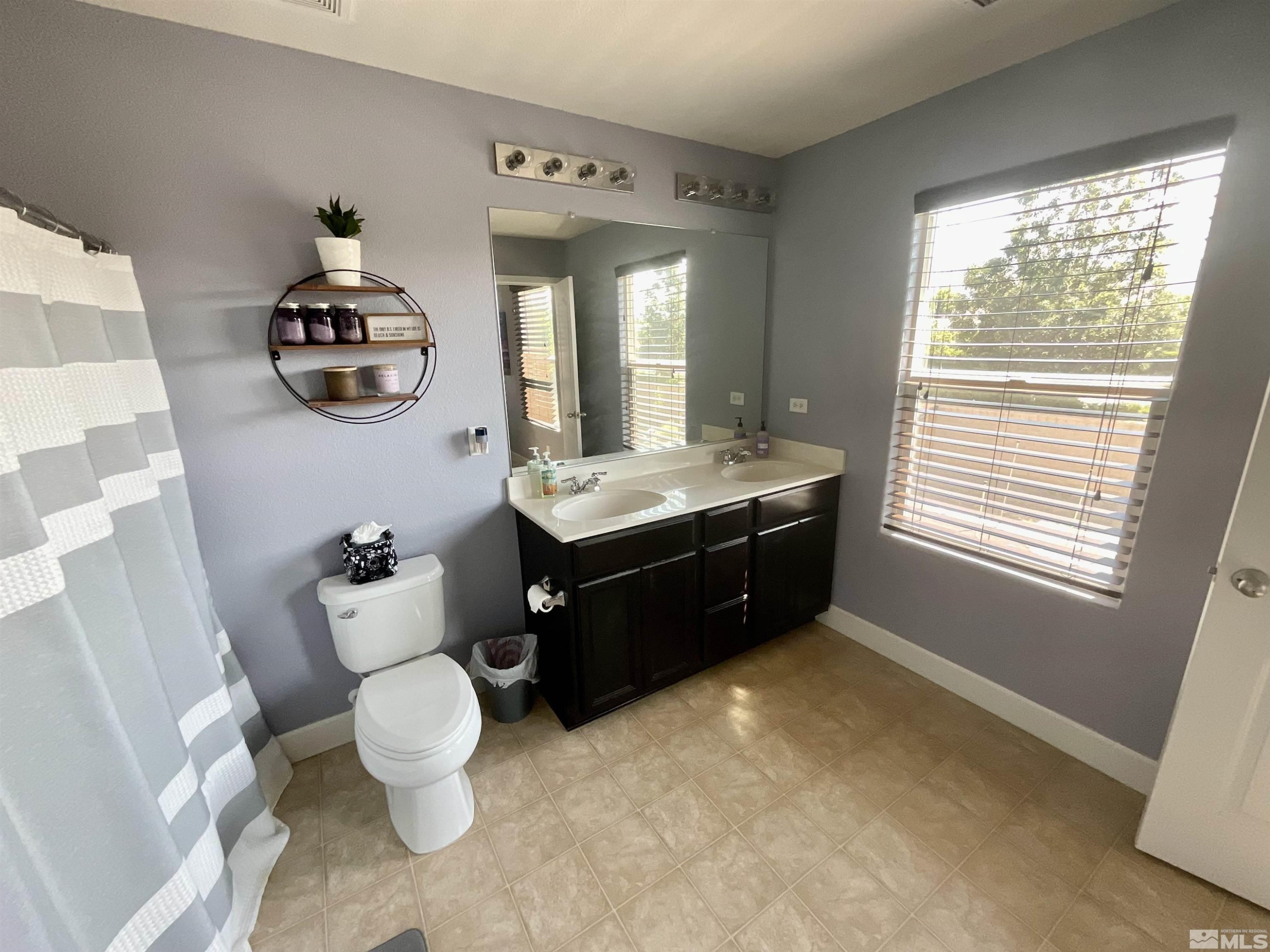 11640 Cervino Drive Reno, NV 89521 - Photo 17 of 26 a bathroom with a sink vanity mirror and toilet