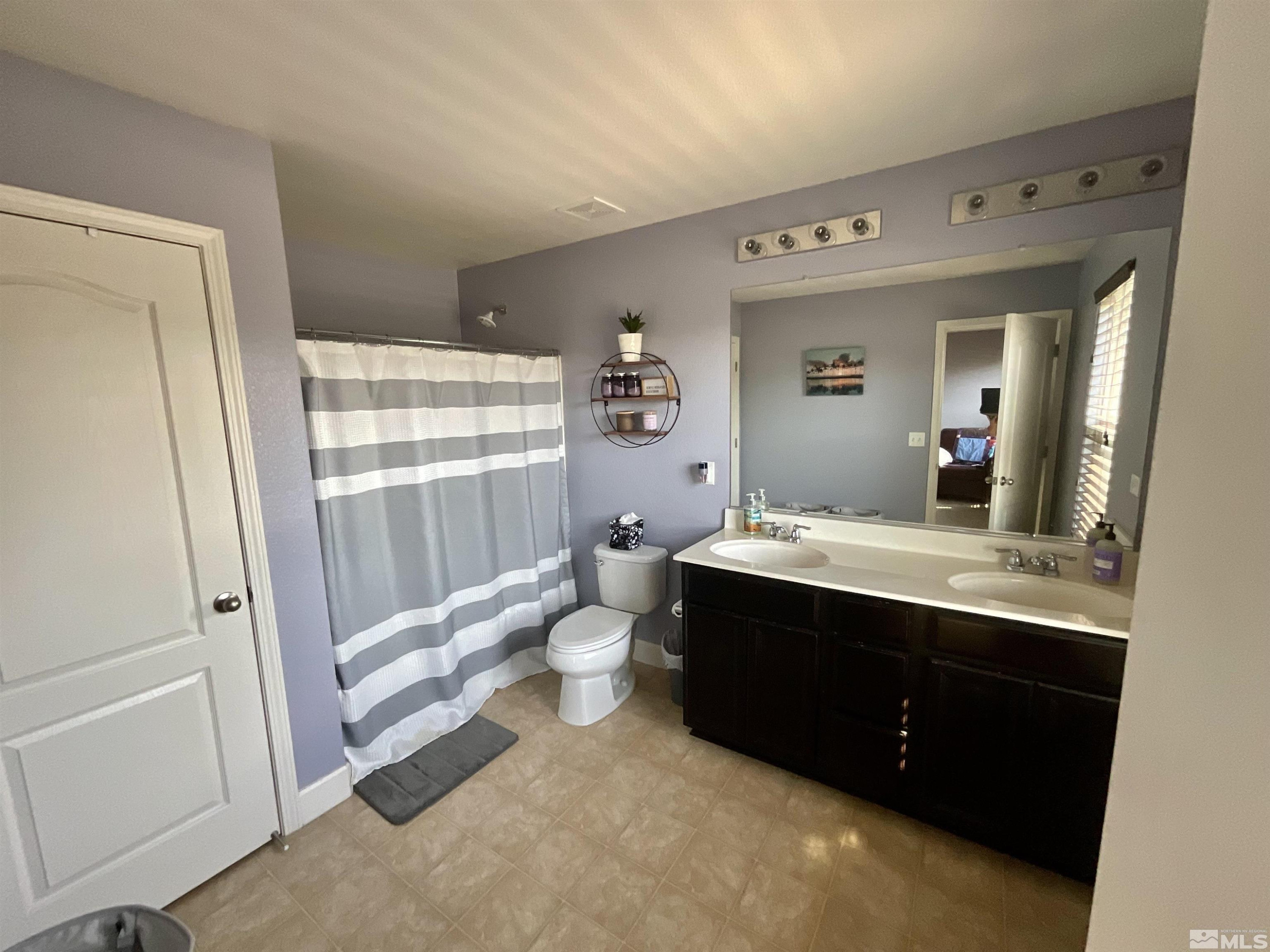 11640 Cervino Drive Reno, NV 89521 - Photo 18 of 26 a bathroom with a sink mirror vanity and toilet