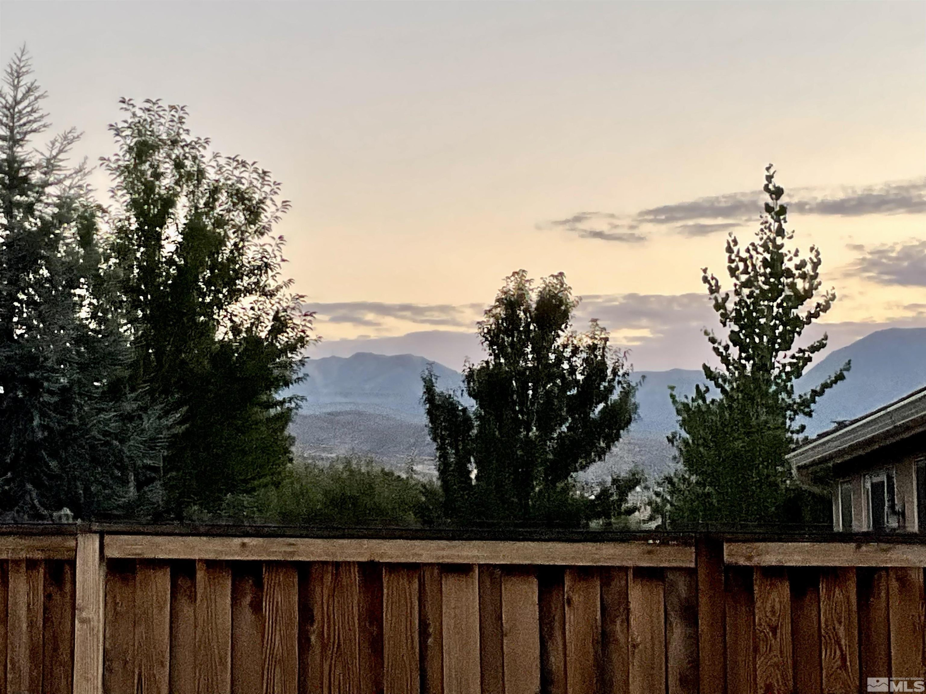 11640 Cervino Drive Reno, NV 89521 - Photo 25 of 26 a wooden fence with trees in the background