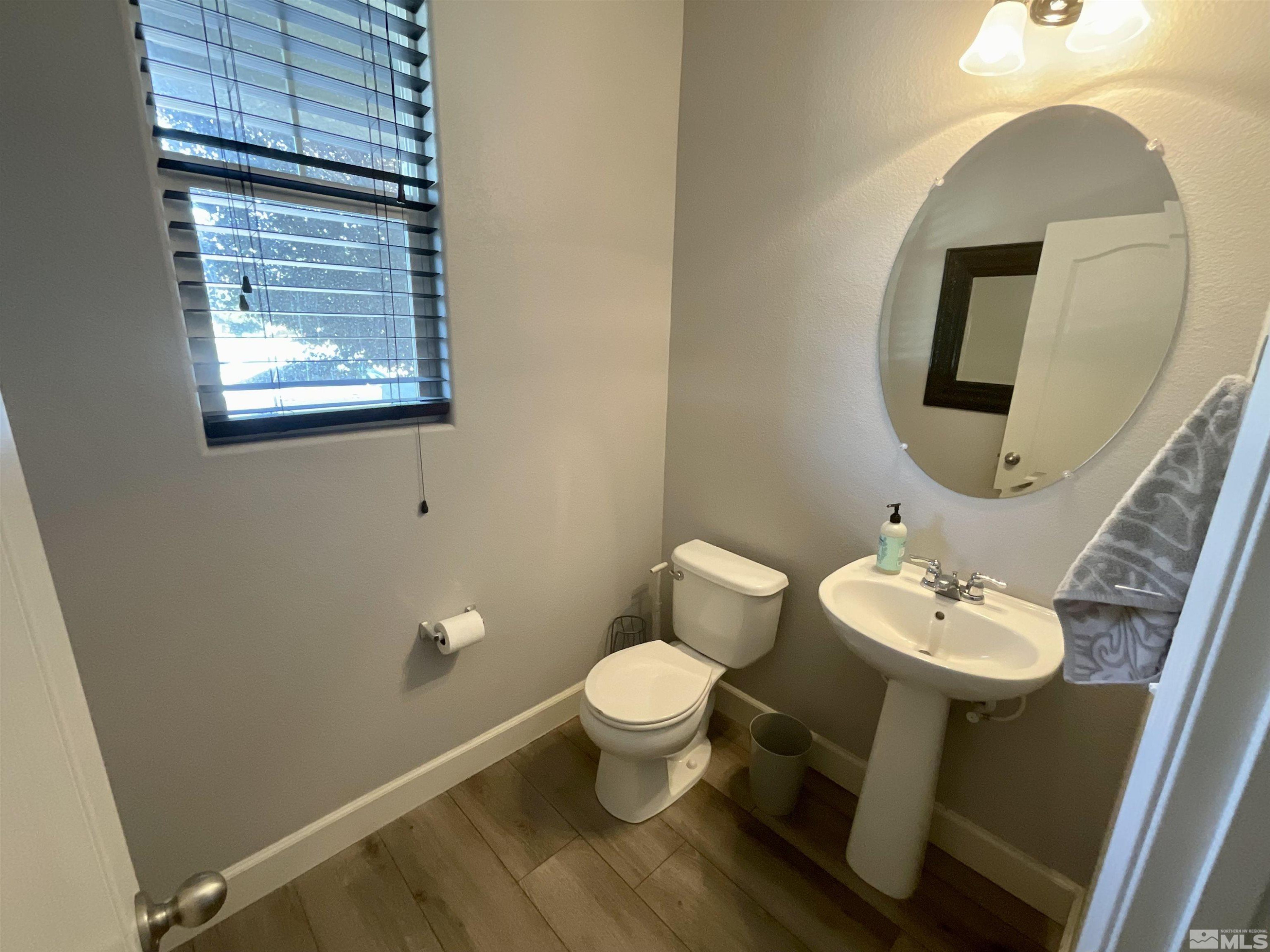 11640 Cervino Drive Reno, NV 89521 - Photo 3 of 26 a bathroom with a toilet sink and mirror