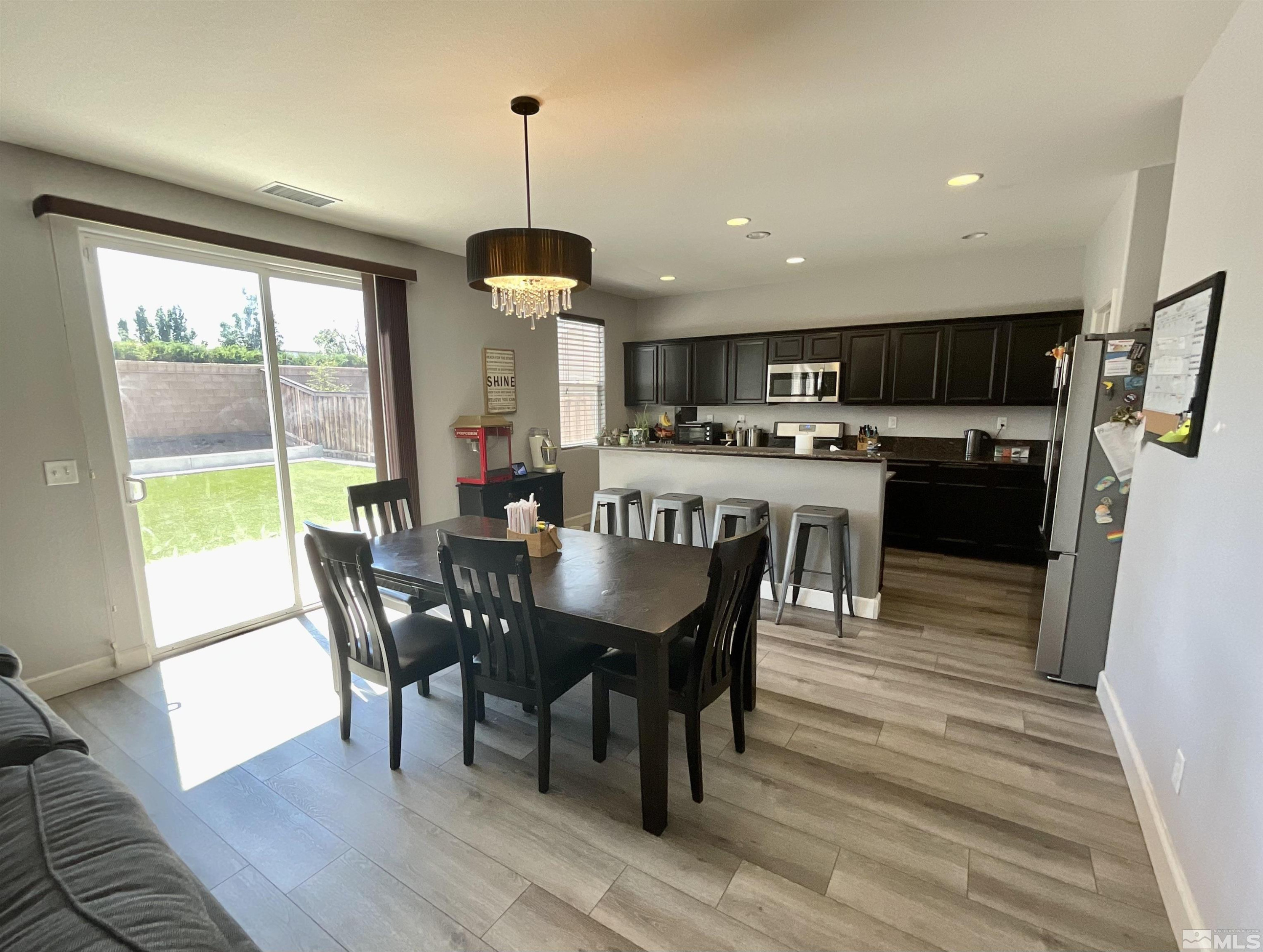 11640 Cervino Drive Reno, NV 89521 - Photo 7 of 26 a view of a dining room and livingroom with furniture wooden floor a chandelier