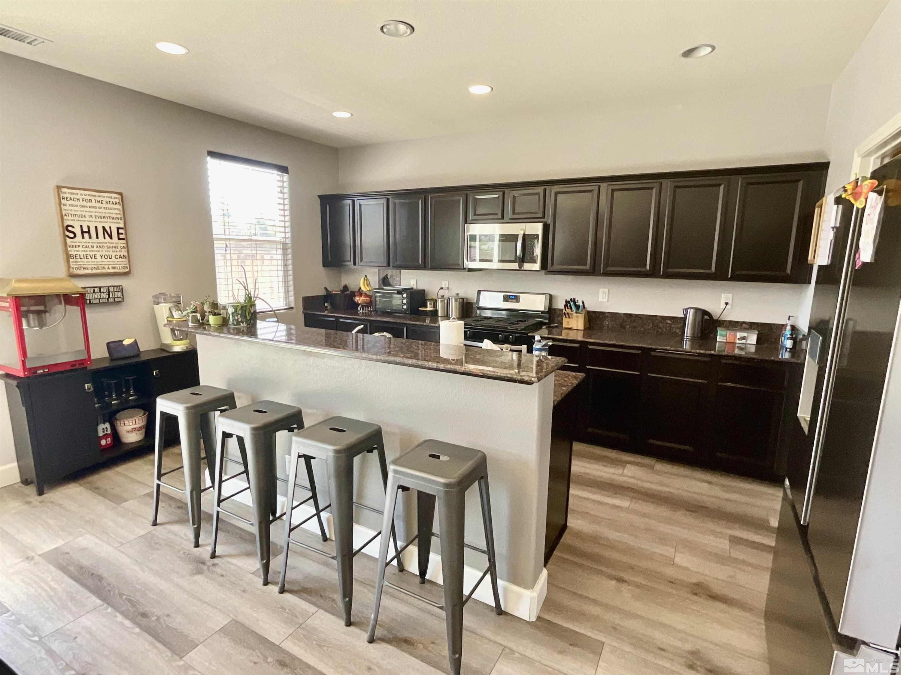 11640 Cervino Drive Reno, NV 89521 - Photo 8 of 26 a kitchen with granite countertop a sink cabinets and stainless steel appliances