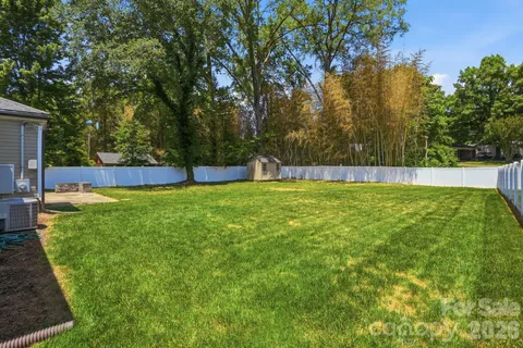 a view of green field with trees in the background