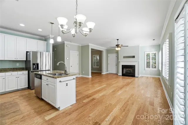 a view of kitchen with sink microwave and refrigerator