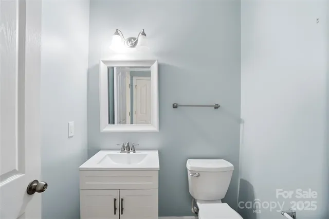 a bathroom with a sink toilet and mirror