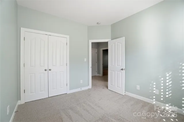 a view of an empty room with closet area