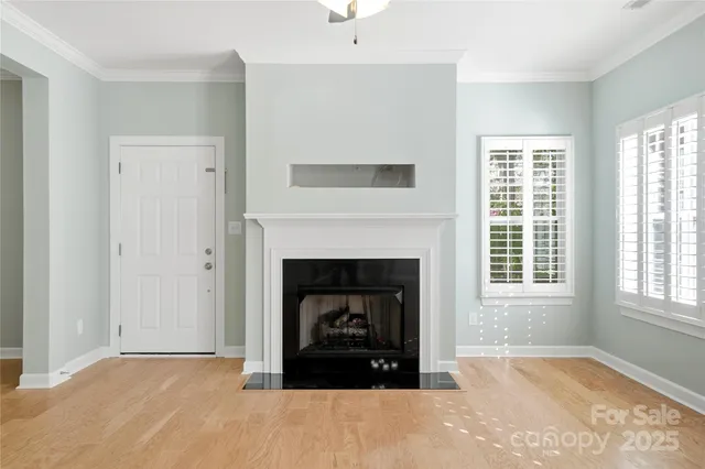 a living room with a fireplace and a window