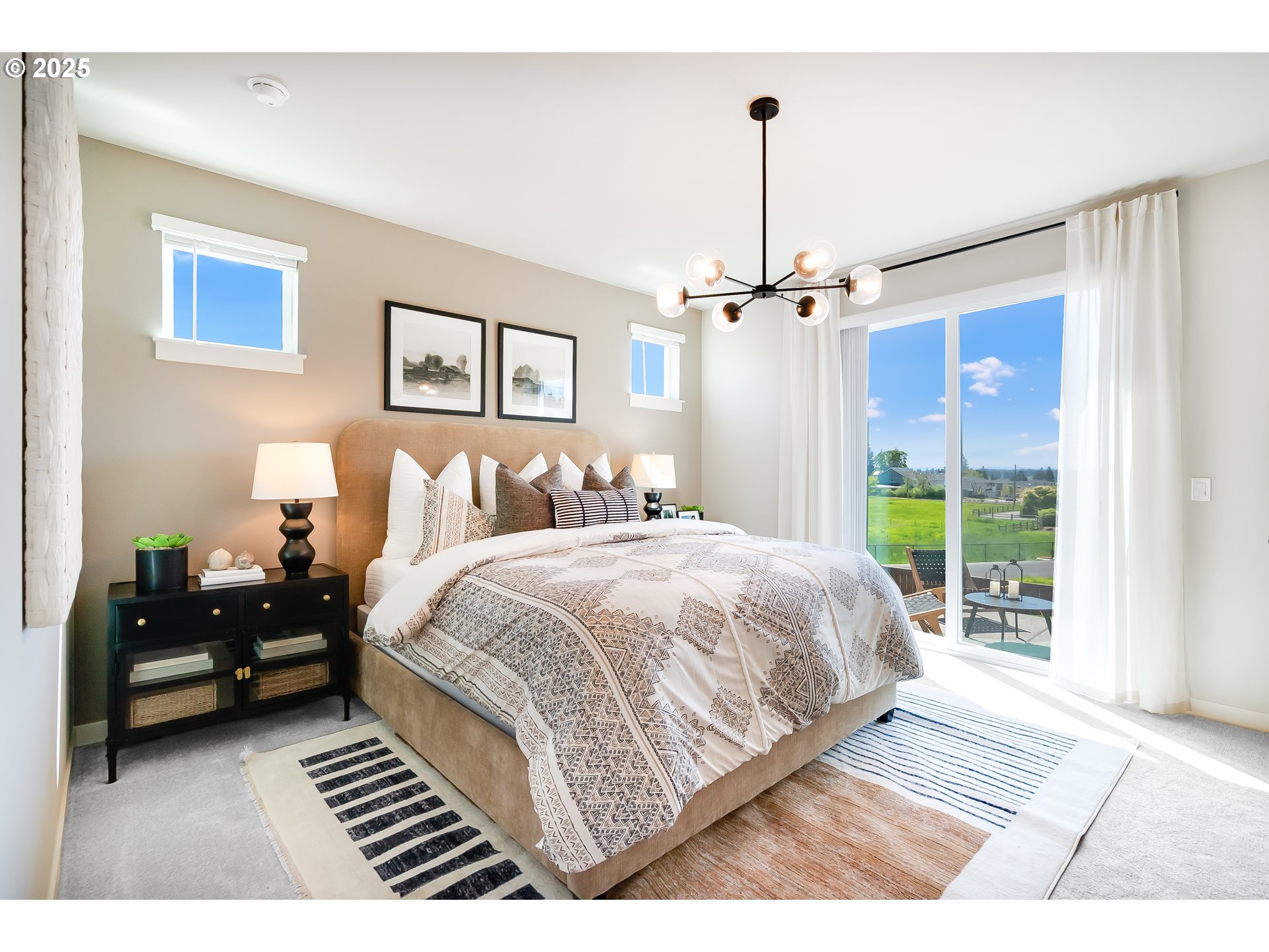 5562 North 88th Avenue Camas, WA 98607 - Photo 27 of 48 a bedroom with a large bed and a chandelier