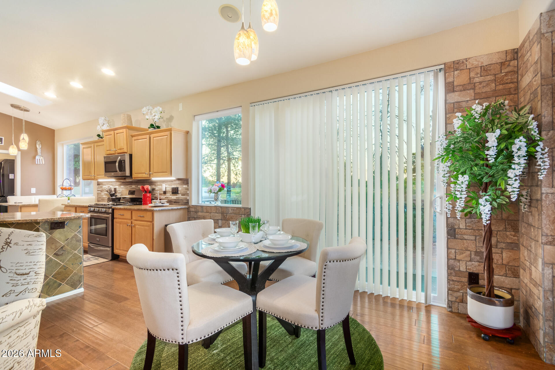 3341 East Fremont Road Phoenix, AZ 85042 - Photo 13 of 40 a dining room with furniture and wooden floor