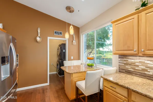 a kitchen with stainless steel appliances granite countertop a refrigerator and a sink