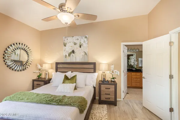 a bedroom with a bed and wooden floor