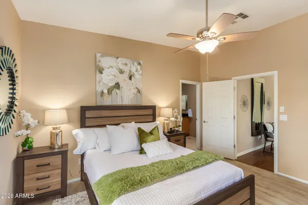 a bedroom with a bed and a chandelier