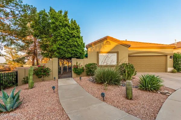a view of a house with a small yard and plants