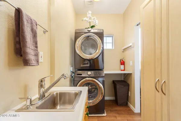 a utility room with sink dryer and washer
