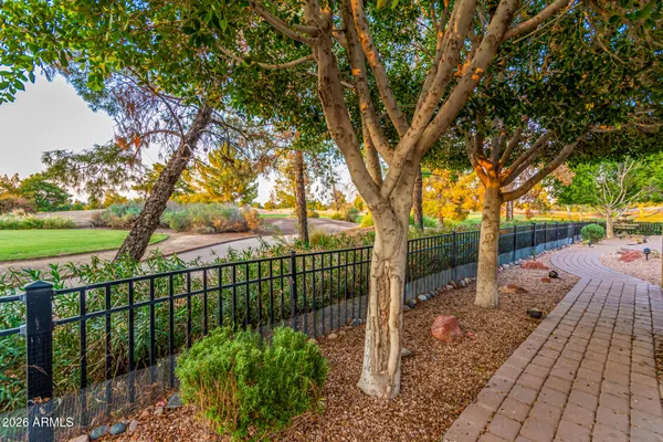 a view of a pathway with a wrought fence