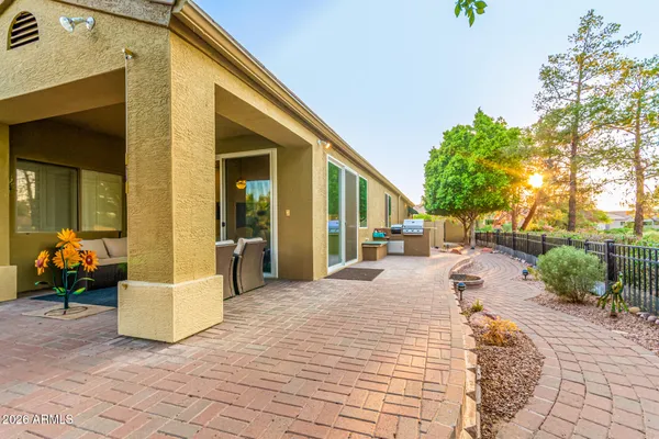 a view of a house with backyard and sitting area