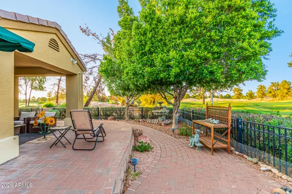 a view of a patio with a table and chairs under an umbrella