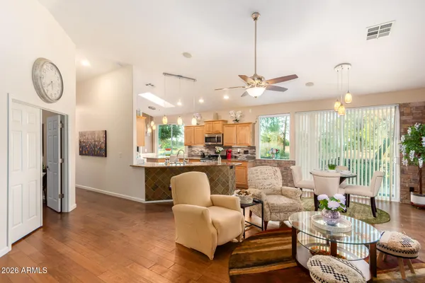 a living room with furniture a large window and a chandelier