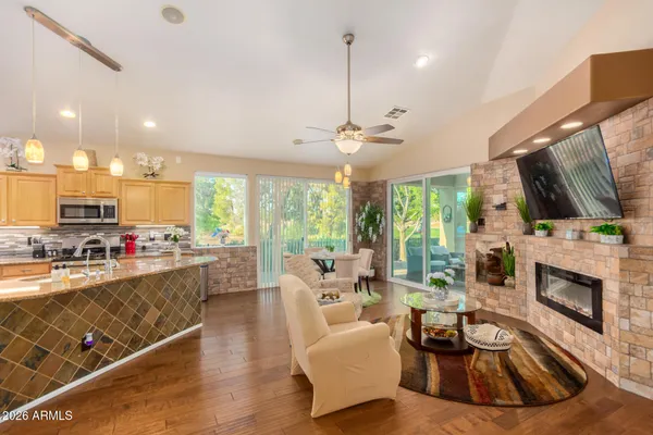 a living room with furniture fireplace and flat screen tv