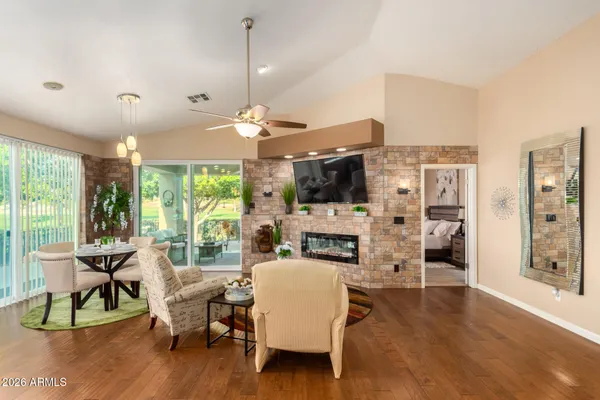 a living room with furniture a flat screen tv and a large window