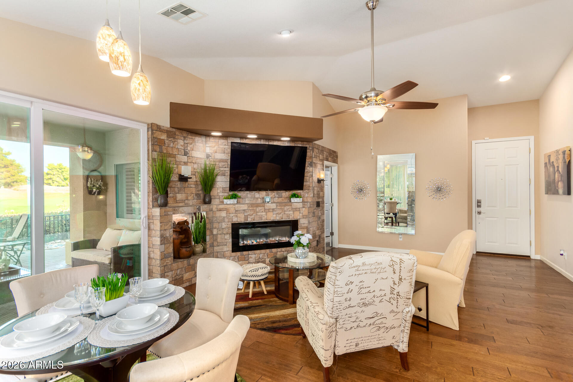 3341 East Fremont Road Phoenix, AZ 85042 - Photo 9 of 40 a living room with furniture a fireplace and a flat screen tv