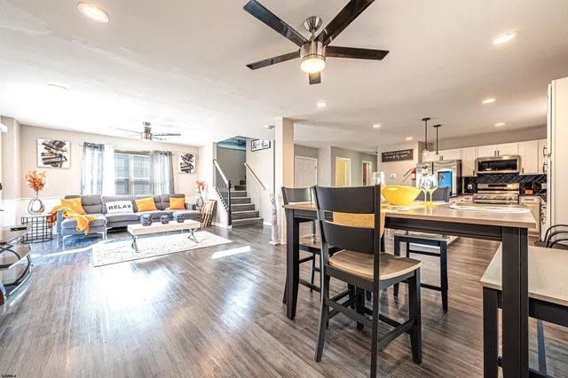 a living room with furniture and kitchen view