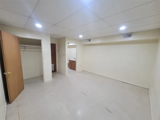 an empty room with entrance and windows