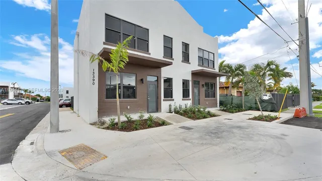 a view of a brick building next to a yard