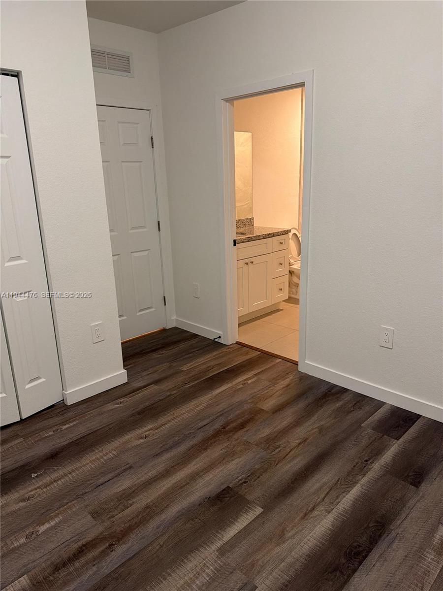 13390 Southwest 251st Terrace, Unit 1 Homestead, FL 33032 - Photo 11 of 22 a view of empty room with wooden floor