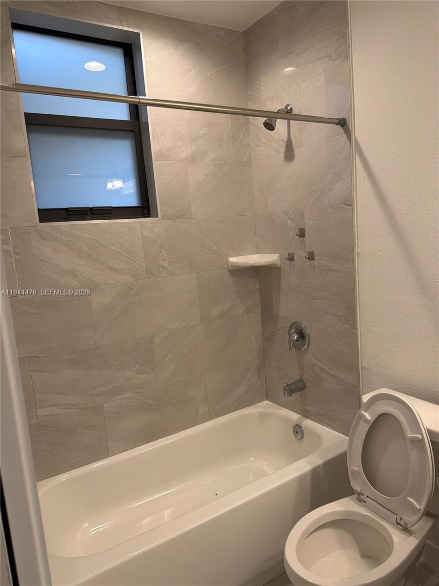 13390 Southwest 251st Terrace, Unit 1 Homestead, FL 33032 - Photo 18 of 22 a bathroom with a toilet a sink and bathtub